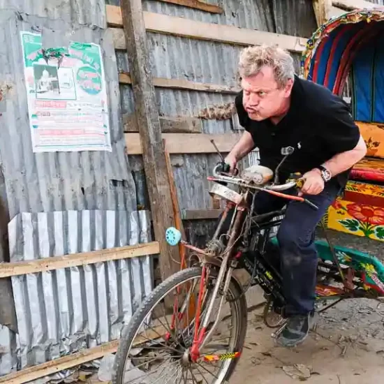 Foreign tourist paddling a rickshaw in Bangladesh