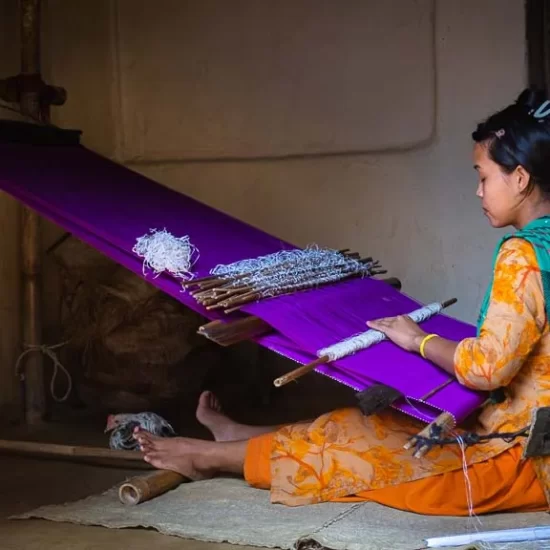 Local Manipuri tribal lady waving her textile in Sreemangal area