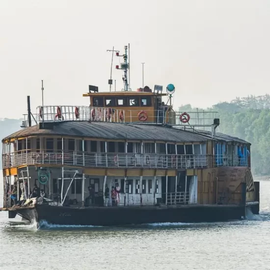 Paddle steamer cruising through narrow rivers of south bengal