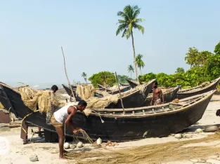 Fishermen are fixing their fishing boats on Kuakata sea beach