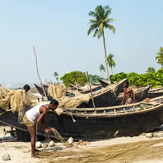 Fishermen are fixing their fishing boats on Kuakata sea beach