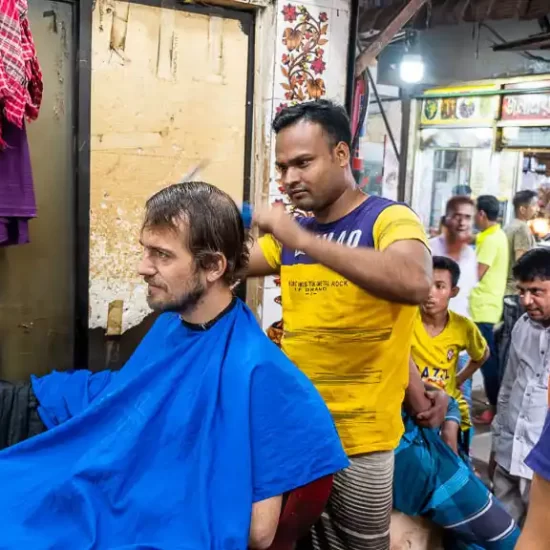 a foreigner takes hair cut in old dhaka saloon