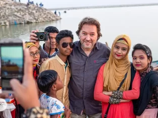 a group of local folks are taking memorable picture with tourist