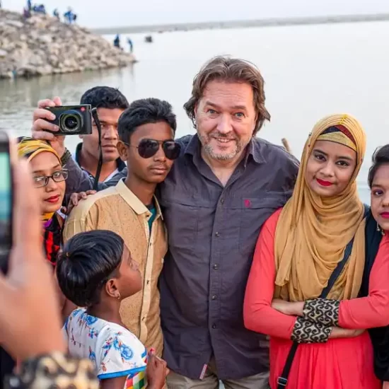 a group of local folks are taking memorable picture with tourist