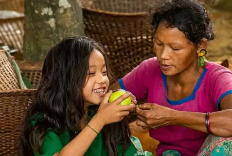 A Tripura girl is incredibly happy with a fruit gift from her mother