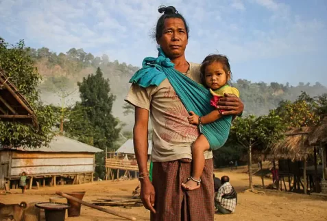 Pangkhua Man with his child on his cloth bag in Chittagong hill tracts